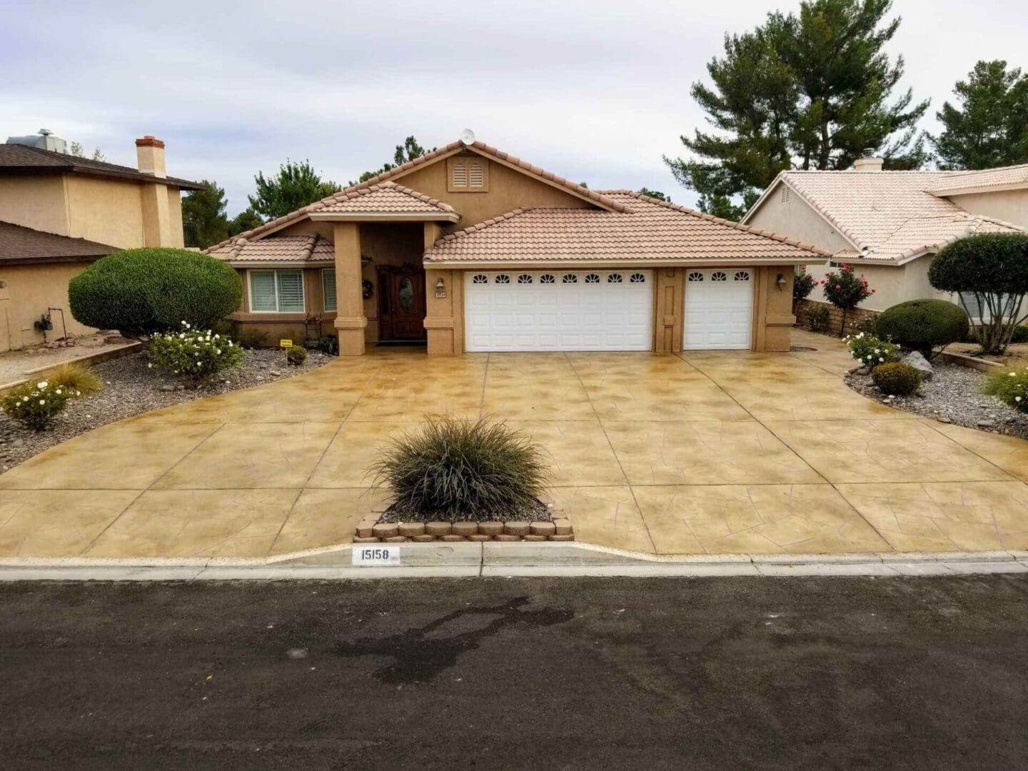 A house with a driveway and two garage doors.