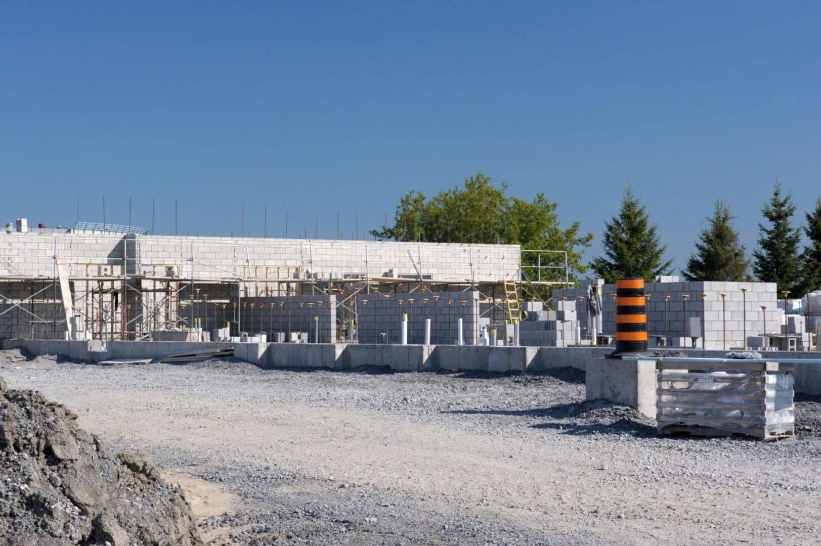 A construction site with some concrete blocks and trees