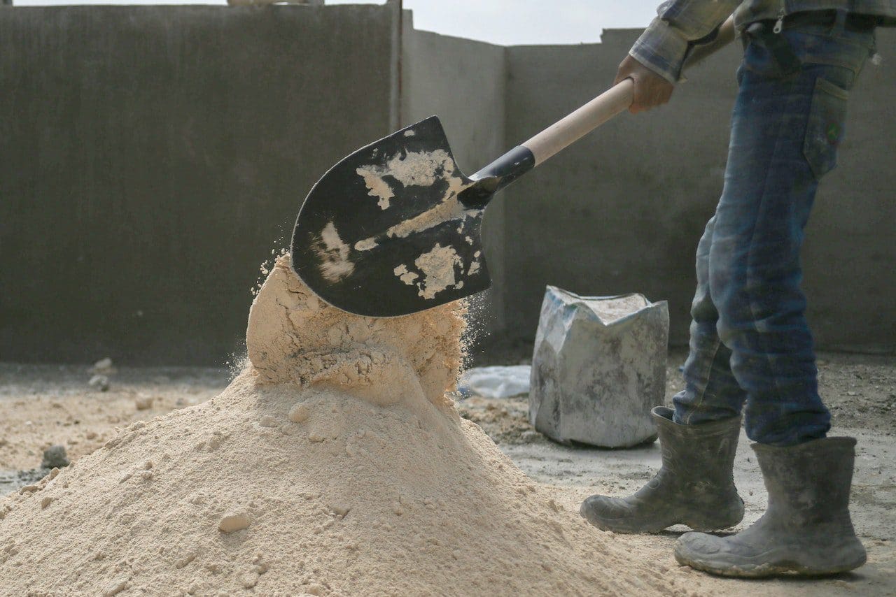 A person with a shovel in the sand