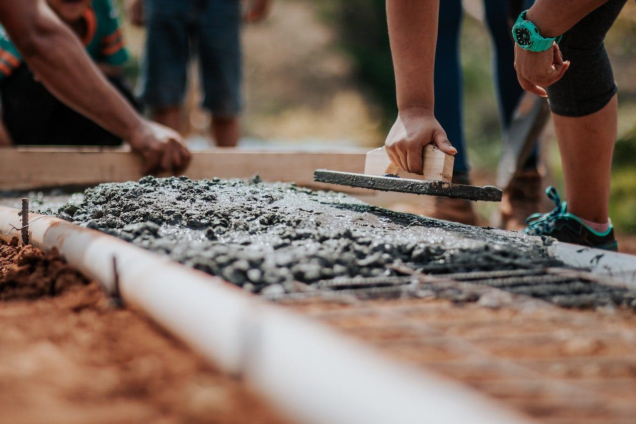 A group of people working on concrete.